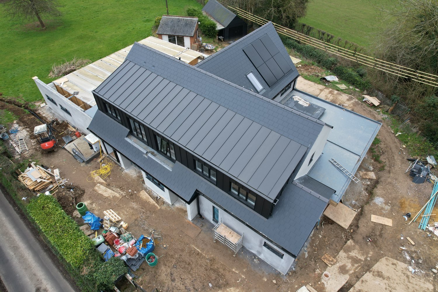 A King Roofing project — contemporary zinc and slate roof on a new-build home